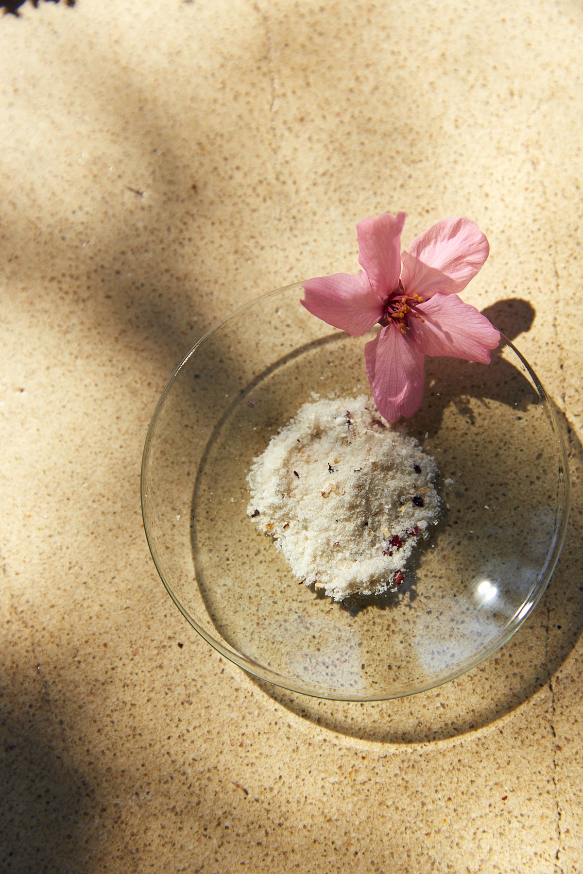 Placeholder: Baobab & Orange Peel Foaming Micro Polish powder texture sample in a glass dish with a pink flower.